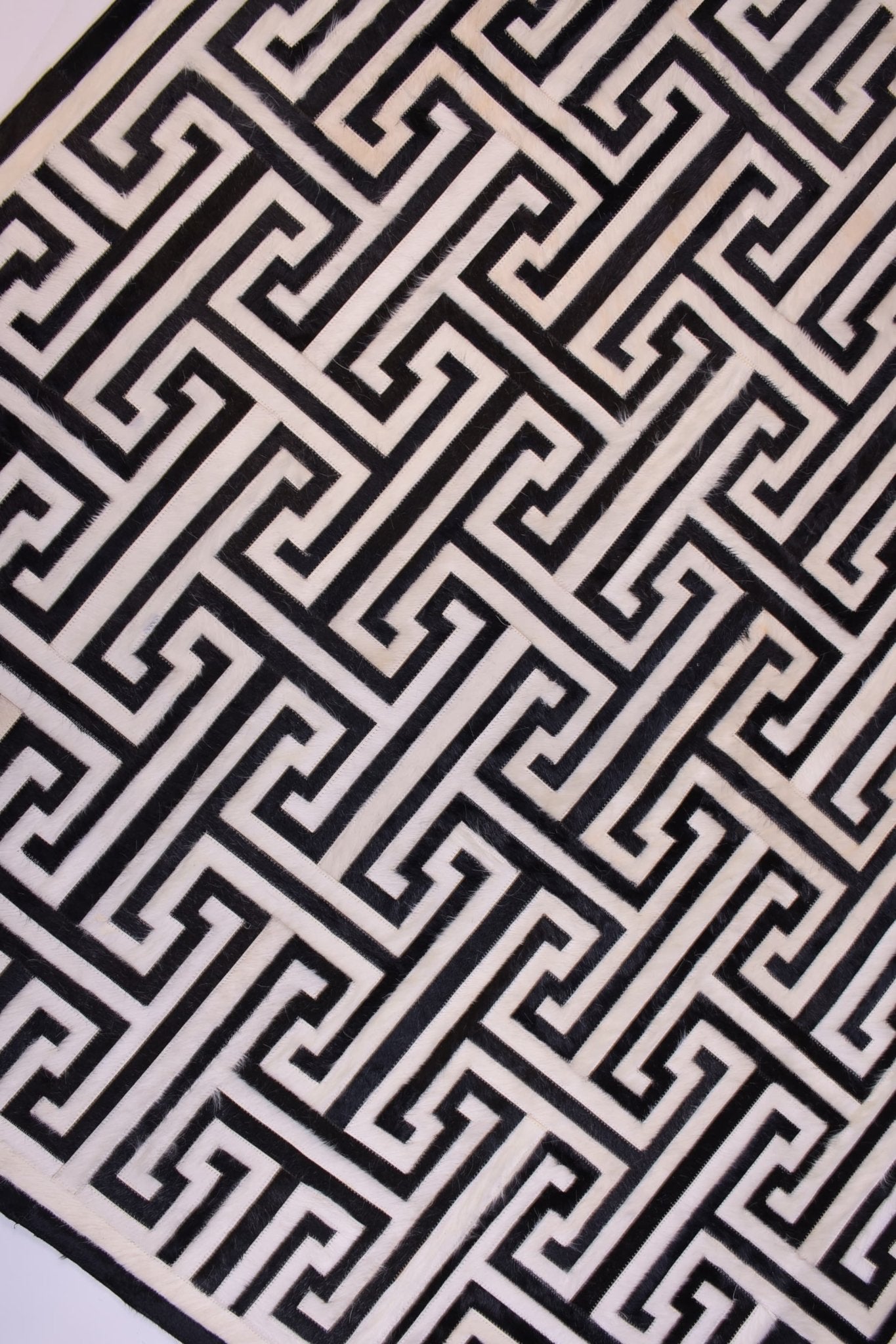 T MODEL – Maze-Inspired Cowhide Patch Rug
