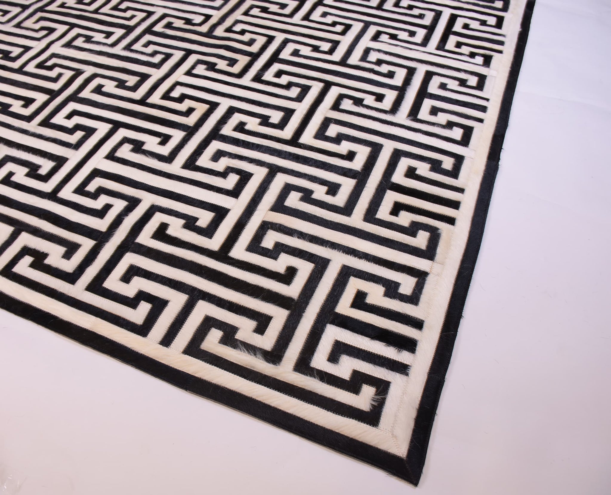 T MODEL – Maze-Inspired Cowhide Patch Rug