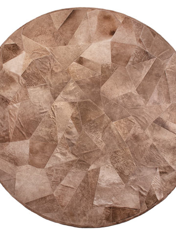 Round patchwork cowhide rug in Taupe natural tones from Homelosophy