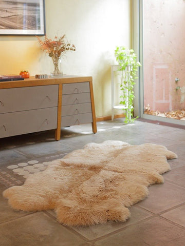 Quad Sheepskin Rug in beige camel made from four ethically sourced Patagonian sheepskins, with organic edges and plush wool texture.