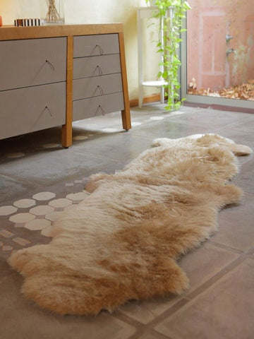 Sheepskin Runner Rug made from natural Patagonian wool in elongated beige camel form with organic hide shape and suede backing.